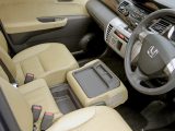 The Honda FR-V's centre front seat folds forward to reveal a tray with cupholders – handy on your caravan holidays