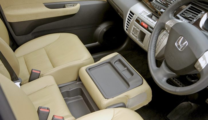 The Honda FR-V's centre front seat folds forward to reveal a tray with cupholders – handy on your caravan holidays