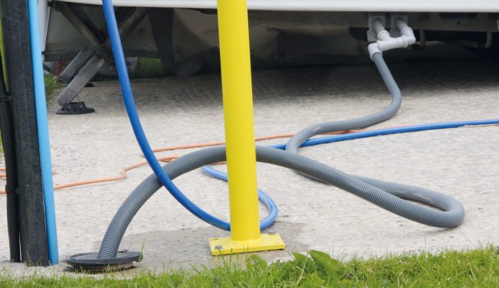 Some campsites have full-service pitches – here, waste water is carried from the caravan using a long hose