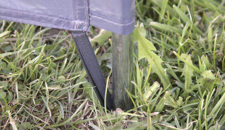 Similarly, small straps at the base hook around the spikes prior to them being pushed into the ground