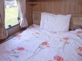 There's a fixed French bed at the rear of the Swift Lifestyle 4, reviewed on TV by Practical Caravan for The Caravan Channel
