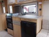 The kitchen's Thetford cooker has an oven, grill, electric hotplate and three gas burners, a microwave and a 113-litre Thetford fridge