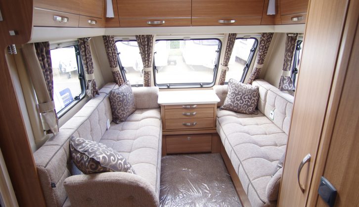 The front lounge in this large caravan has two comfortable sofas, a centre drawer unit and huge overhead lockers
