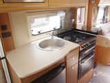 The amidships kitchen has plenty of cupboards, a domestic-style cooker, an 800W microwave oven and a 110-litre fridge
