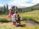 The girls try the ice-cold water in King Creek at Lassen Volcanic National Park, north-eastern California