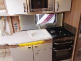 The well-equipped kitchen has a microwave oven and a Thetford Aspire 2 cooker with a dual-fuel hob and separate oven and grill, plus a worktop extension