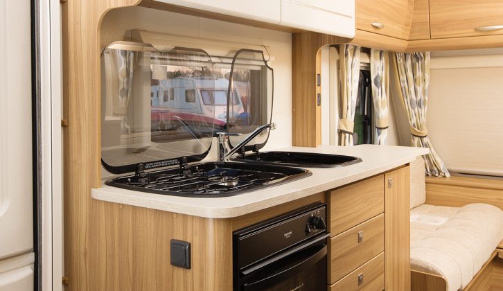 The galley is well-equipped, and has a handy worktop extension. Storage areas include large overhead lockers for  crockery and groceries.