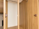 The divider between the twin wardrobe doors hinders access