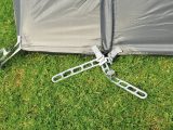 Ladder bands and plastic pegs secure the awning, but we'd buy metal tent pegs just in case!