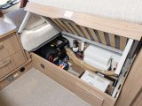 The offside seat box is cluttered by plumbing and heating equipment