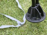 The two arch ends at each corner slot into a single foot, which should be pegged to the ground where the guide strap indicates