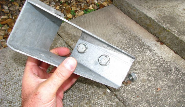 You might like to insert the bolts (and washers) through the holes in the bracket before positioning