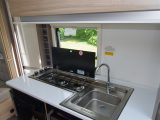 Smart yet understated storage sits above the hob and worktop