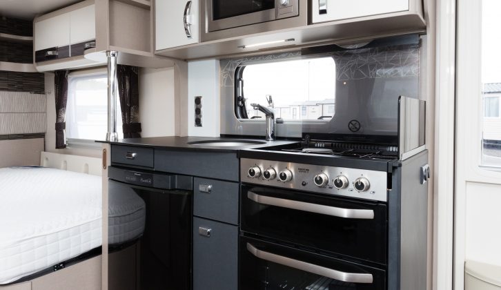 Contrasting upper and lower kitchen units feature in the Sterling Elite 630, which also has a fixed French bed and bunks