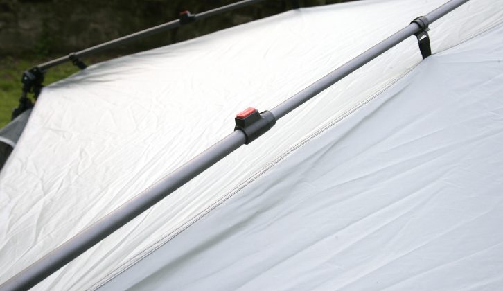 While the roof is in reach, extend the four telescopic poles until they click in place
