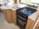 A large window lets light flood into the kitchen, which has a Thetford Caprice cooker with separate oven and grill as part of its spec