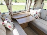 The extendable central table is useful when lounging – read more in the Practical Caravan Bailey Pegasus Brindisi review