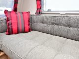 ￼The ‘Baptiste’ upholstery joins the bright-red soft furnishings to create a striking, modern décor