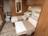 Twin single beds set across the van are separated by a centre chest