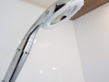 New bifold doors lead to a lined cubicle with an EcoCamel Orbit shower head
