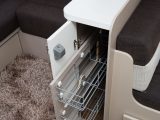 Pull-out wire baskets make the most of this slim cupboard