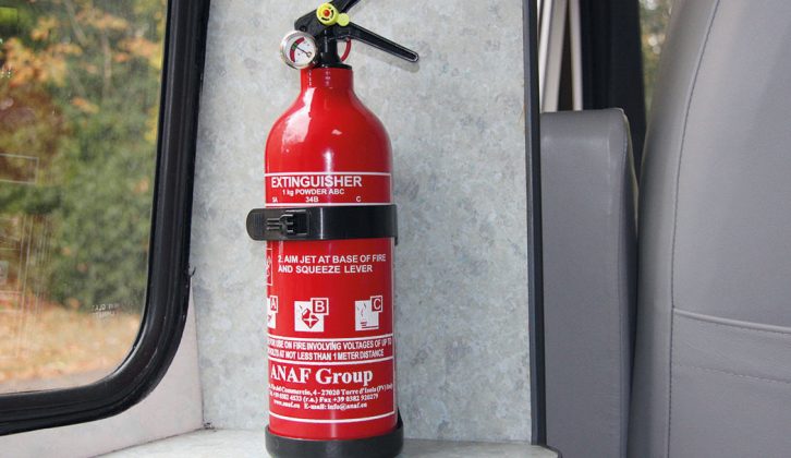 Fit a fire extinguisher away from the place where a fire could possibly break out in your caravan