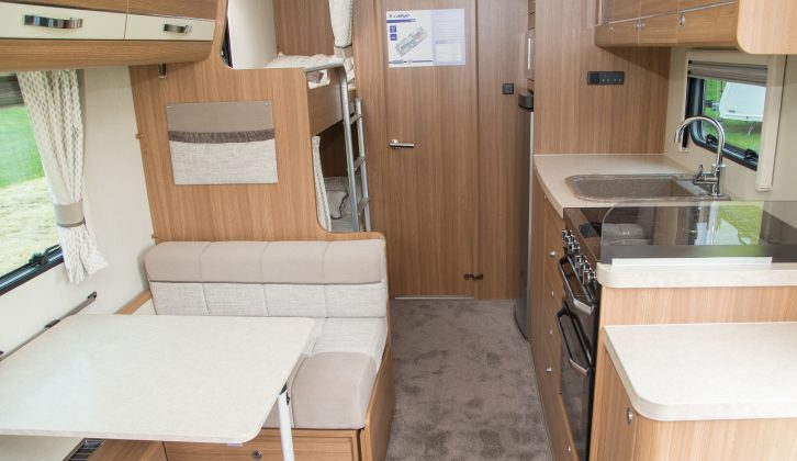 Beyond the dinette are the bunks and the end washroom – note the cosy carpet underfoot