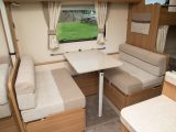 The sides of the double dinette pull out to make a 1.81 x 1.14m double bed, but take up floor space