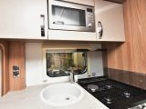 The sink has a clip-on drainer, there's a dual-fuel hob, separate oven and grill, and a microwave that's sited quite high up