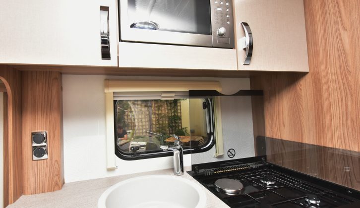 The sink has a clip-on drainer, there's a dual-fuel hob, separate oven and grill, and a microwave that's sited quite high up