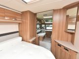 There's a neat corner vanity unit at the foot of the 1.85m x 1.33m island double bed, with TV connection points