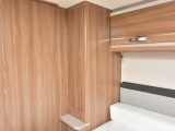 The island bed is flanked by wardrobes, which both have two drawers