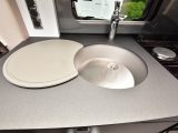 The stainless-steel sink has a chopping board/cover you can use as part of the worktop