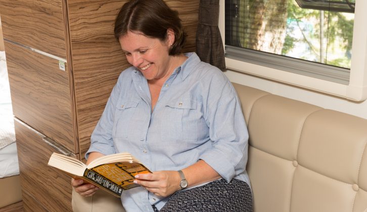 This chair in the lounge is perfect for reading, and it has a high back and bolsters for optimum comfort