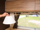A light on an extending arm gives a domestic-style ambience in this van, and is handy for reading