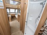 The separate shower cubicle is close to domestic size and there's also a mirrored cupboard and a heated towel rail