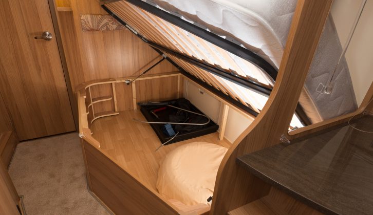 The fixed bed opens on gas struts to reveal a large storage space with external access