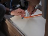Disconnect wires, pass the orange cable back into the van and carefully cut back the sheath