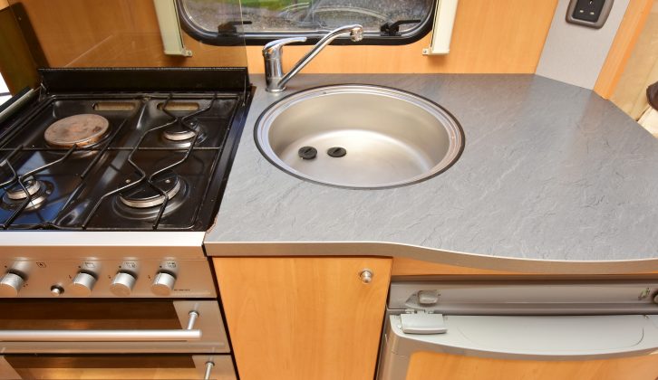The nearside kitchen boasts a dual-fuel hob, a separate oven and grill, ample worktop, a mains socket and a clock