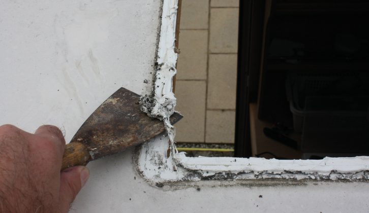 Remove the old mastic from around the edge, being careful not to damage the roof
