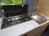 The clever design of the three-burner hob means that spillages drain straight into the sink