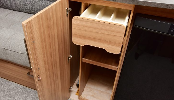 Storage in the kitchen includes a cutlery drawer and shelves