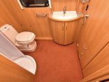 The spacious end washroom has an electric-flush toilet, a circular shower and a wardrobe that is ample for two