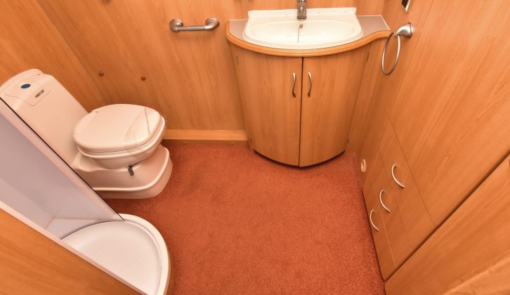 The spacious end washroom has an electric-flush toilet, a circular shower and a wardrobe that is ample for two