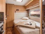 The Knaus StarClass 560 has a fixed double bed with reading lights, a handy shelf and a long window