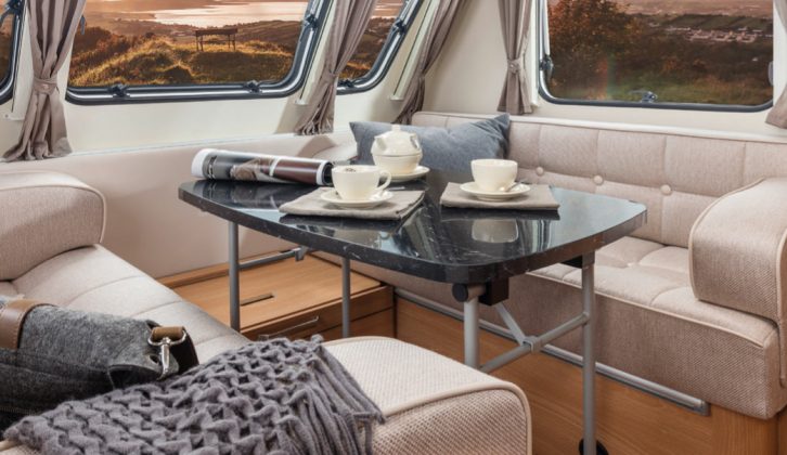 The freestanding dining table is stowed under the bed in a storage area that's accessible from outside the van, too