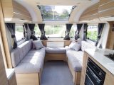 The front windows and opening panoramic rooflight make the lounge feel light and spacious in the Adria Adora Isonzo 613DT