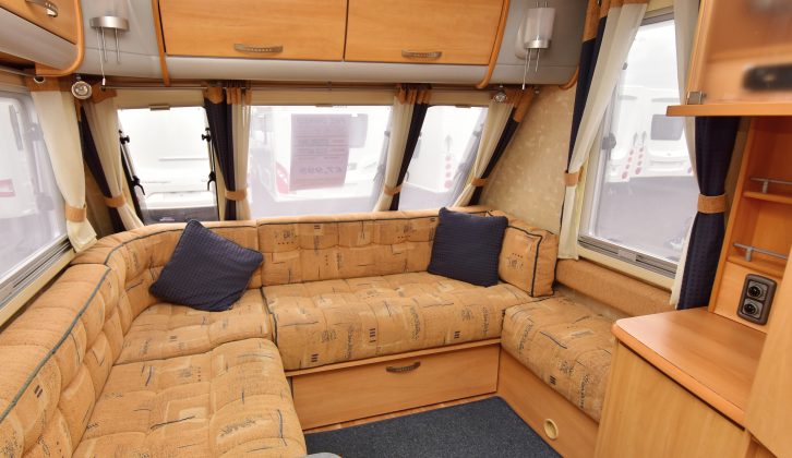 L-shaped lounges were fashionable when the van was new. It feels spacious and the locker lights run on mains power