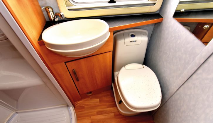 The offside washroom has an electric-flush toilet. Look for cracks in the circular shower cubicle and tray