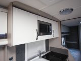 The large overhead cupboards will prove useful on tour, however the microwave is quite high – read more in the Practical Caravan Sterling Eccles 565 review